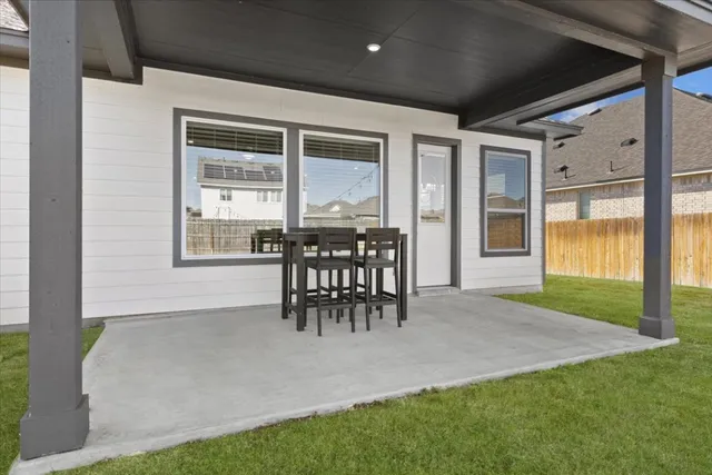 a patio with table and chairs