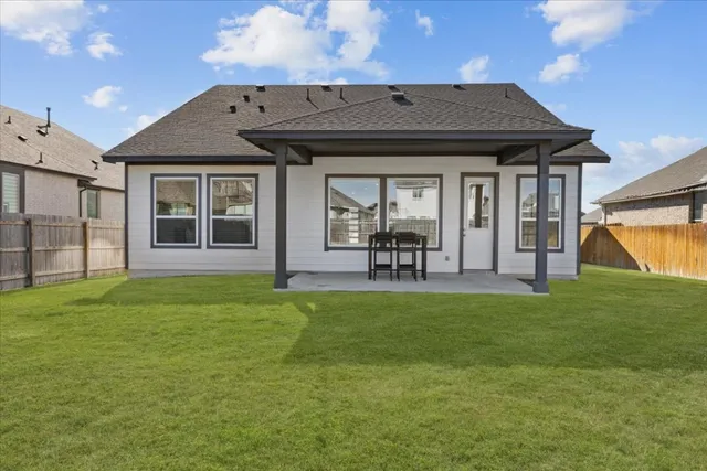 a front view of a house with a garden and patio