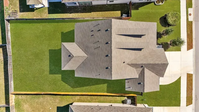 an aerial view of a house with a swimming pool