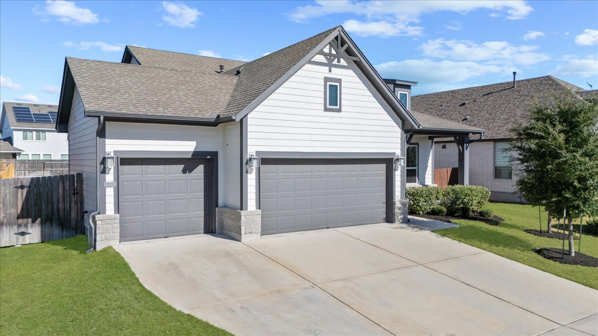 908 Knowles Drive Hutto, TX 78634 - Photo 3 of 37 a front view of a house with a yard and garage