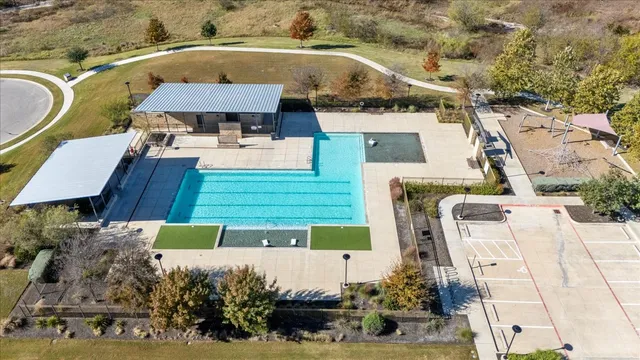 an aerial view of a house with a swimming pool