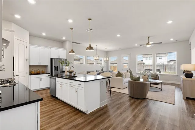 a kitchen with counter top space a sink appliances and cabinets