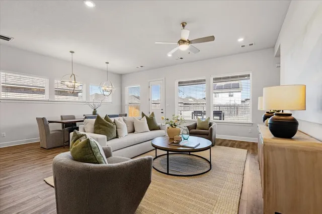 a living room with furniture and a wooden floor