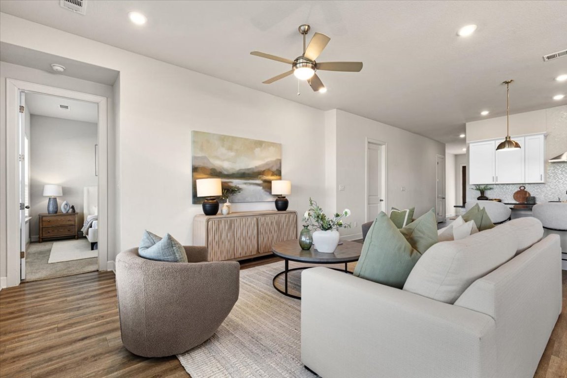 908 Knowles Drive Hutto, TX 78634 - Photo 10 of 37 a living room with furniture and a wooden floor