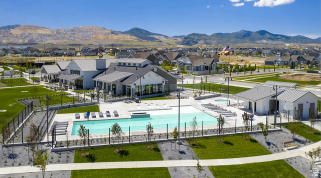 11508 Kitty Hawk Road South Jordan, UT 84009 - Photo 33 of 38 Community pool with an integrated spa, surrounded by a paved patio and lounge seating