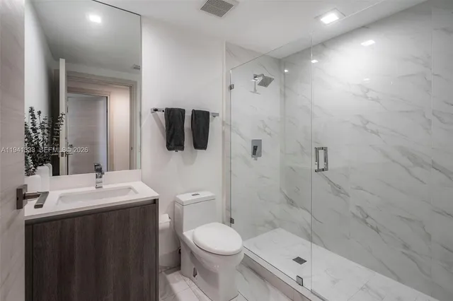 a bedroom with a bed and painting on the wall