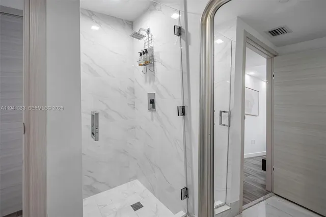 a kitchen with stainless steel appliances a stove a microwave and a refrigerator