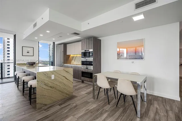 a kitchen with stainless steel appliances granite countertop a sink and a stove