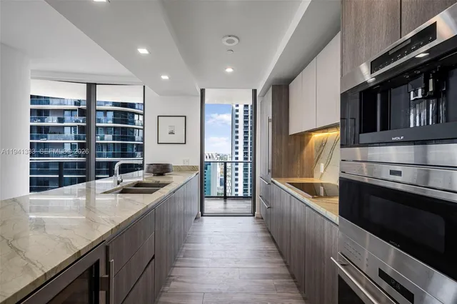 a large bedroom with a bed and wooden floor