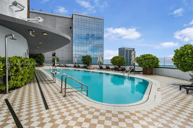 a view of a roof deck with couches and potted plants