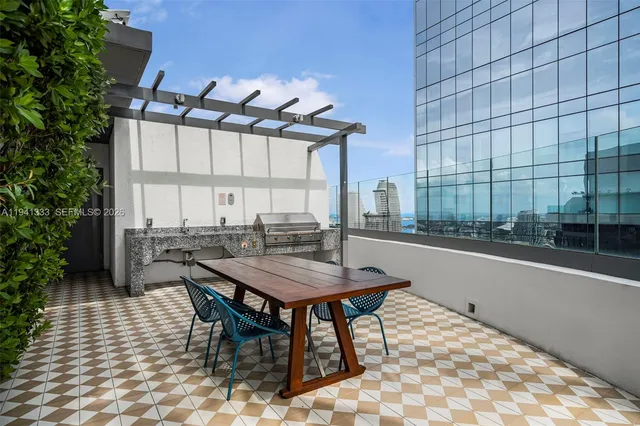 a front view of a multi story building with yard and retail shops