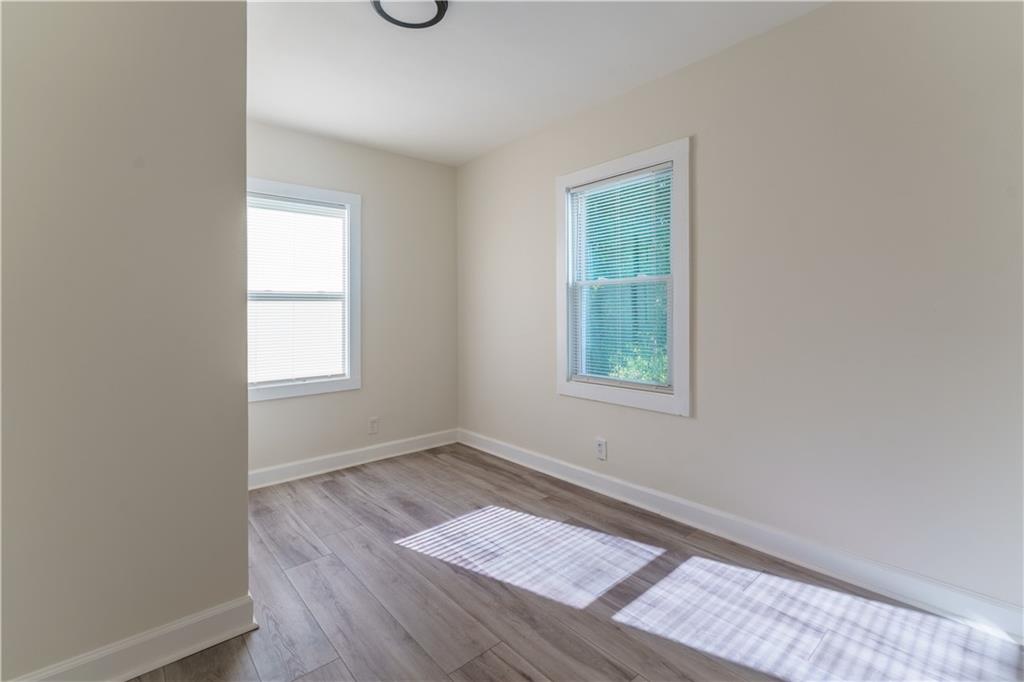 1365 Campbellton Road Southwest Atlanta, GA 30310 - Photo 10 of 36 an empty room with wooden floor and windows