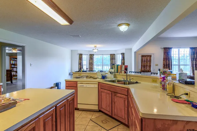 a kitchen that has a sink and a stove in it