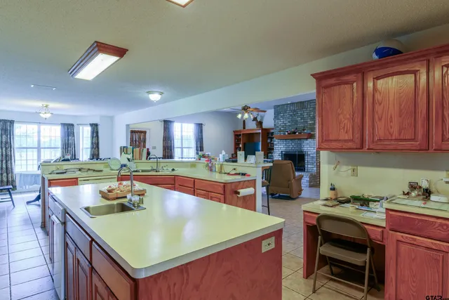 a room with furniture pool table and chairs