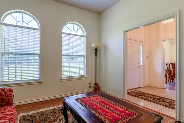 a living room with a bed and a window