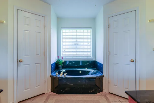a bathroom with a bathtub and shower