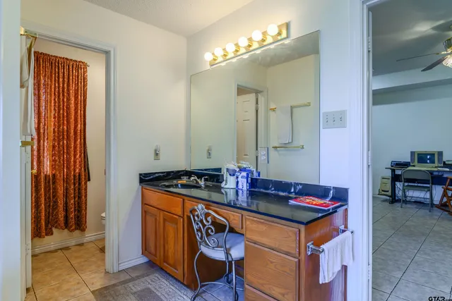 a bathroom with sinks a mirror and a shower