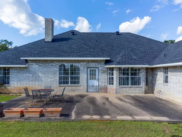 a front view of a house with garden and yard