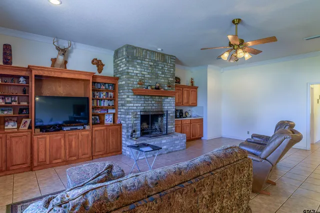 a living room with furniture a flat screen tv and a fireplace
