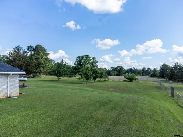 a view of a house with a backyard