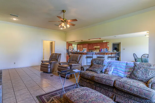a living room with furniture and a ceiling fan