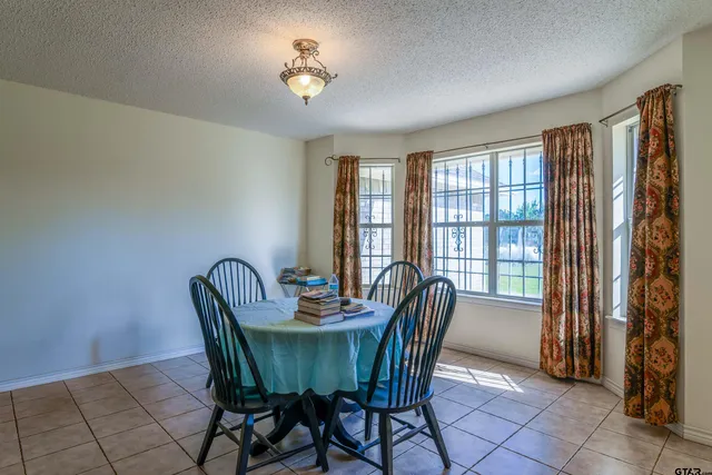 a view of a dining room with furniture and a window