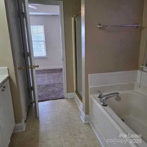 a bathroom with a bathtub and shower