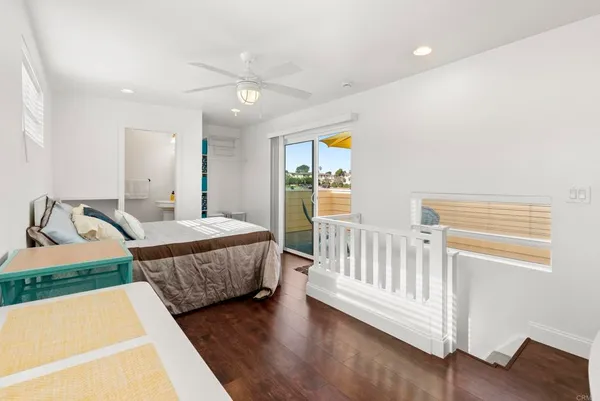 a bedroom with a bed and a table with wooden floor