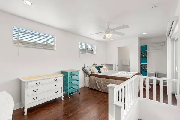 a room with furniture and two windows