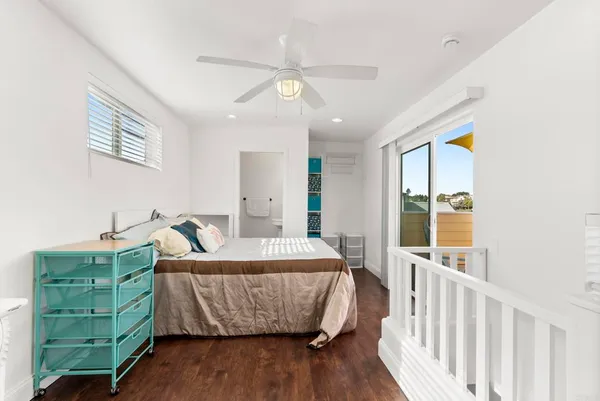 a living room with a bed furniture and a large window