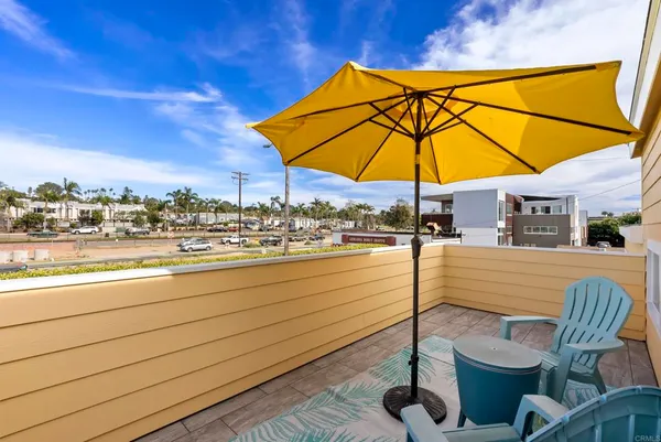 a view of a terrace with furniture and umbrella