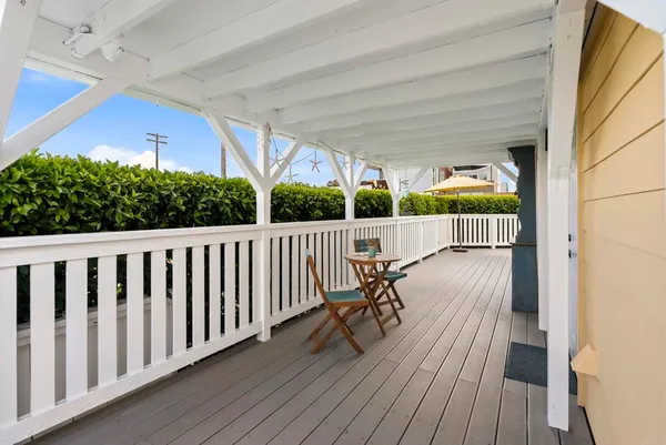 a view of a chairs and table in patio with wooden fence