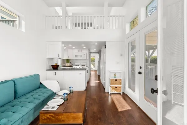 a living room with furniture and a wooden floor