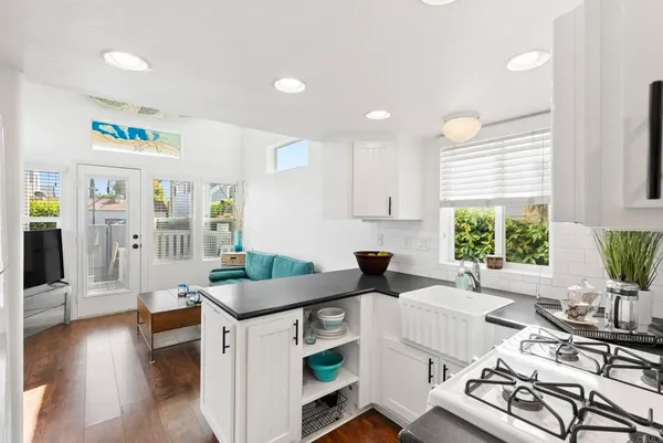 a kitchen with a table chairs stove and cabinets