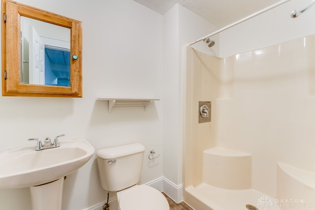 7400 Cook-Jones Road Waynesville, OH 45068 - Photo 47 of 72 This clean bathroom features a convenient shower and a functional pedestal sink.