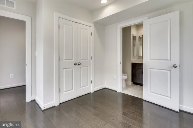 an empty room with wooden floor and a window