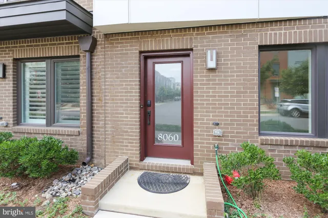 a view of a brick building next to a yard