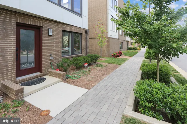 a picture of a room with a white wall and a large mirror