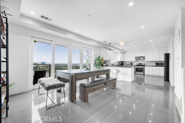 4240 Barrett Road Los Angeles, CA 90032 - Photo 16 of 47 a living room with furniture a kitchen and a chandelier
