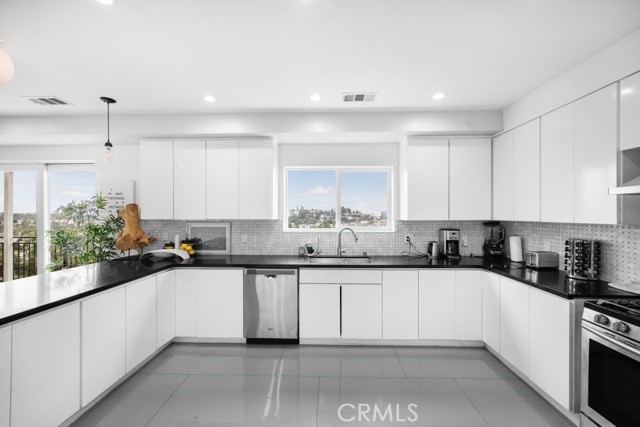 4240 Barrett Road Los Angeles, CA 90032 - Photo 18 of 47 a kitchen with a sink and cabinets