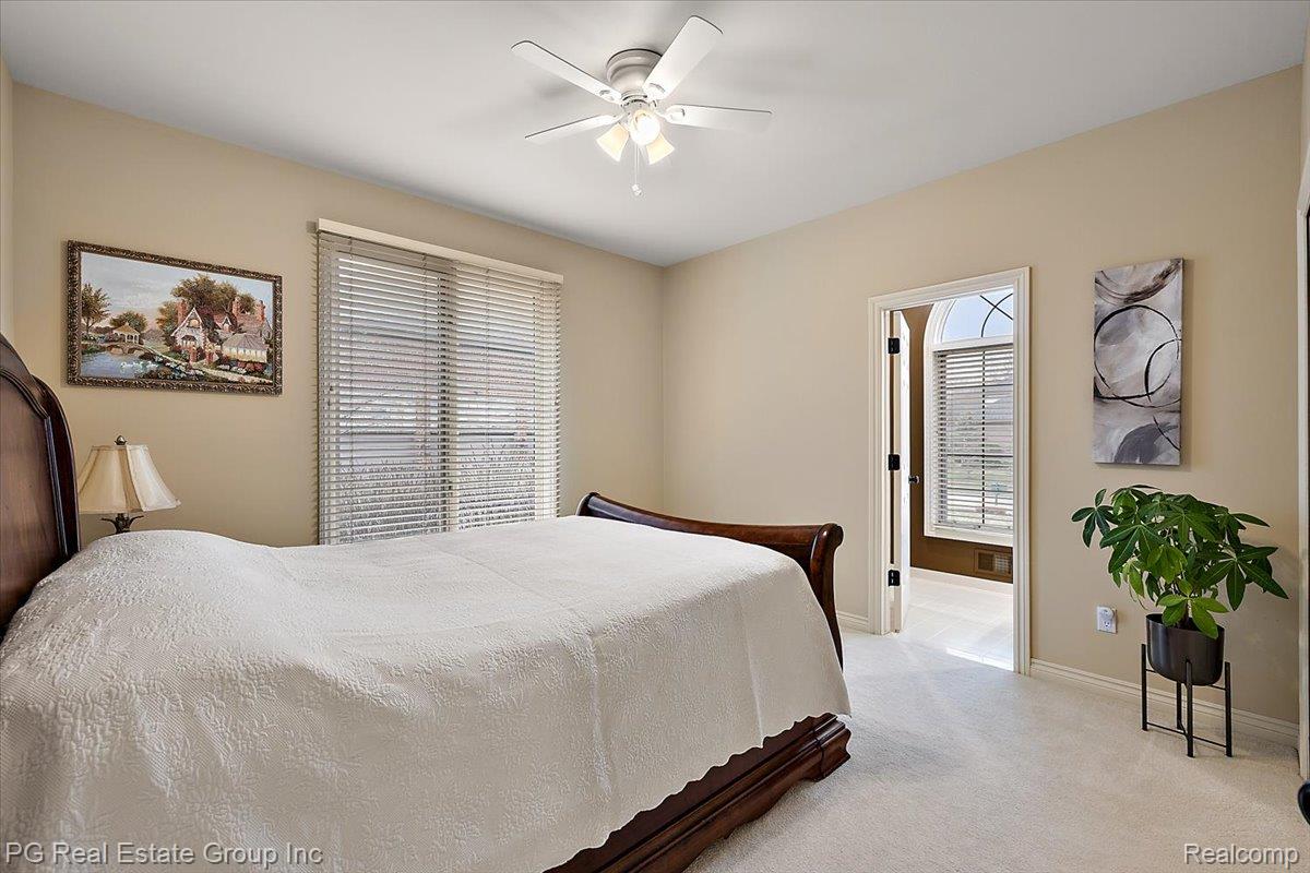 3571 Cedar Brook Drive Rochester, MI 48309 - Photo 44 of 57 Bedroom with light colored carpet and ceiling fan