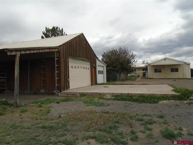 a view of a house with a small yard and plants