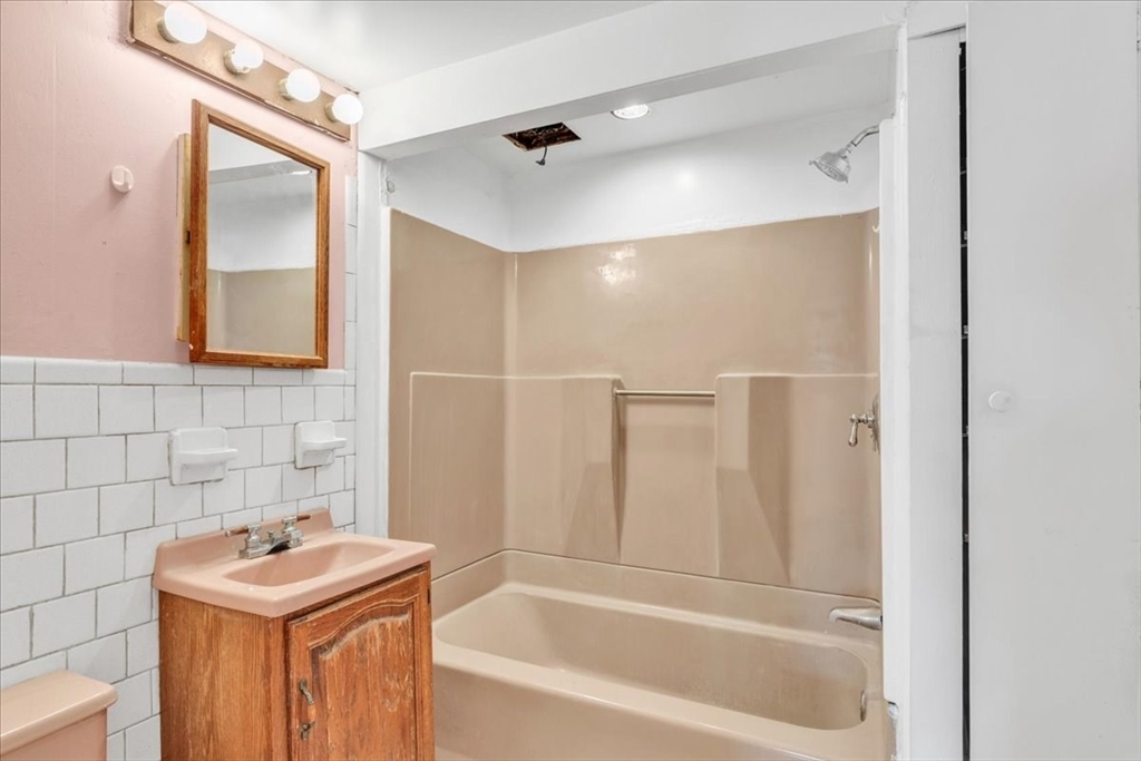 4 Springer Street Boston, MA 02127 - Photo 12 of 18 a bathroom with a sink mirror toilet and bathtub