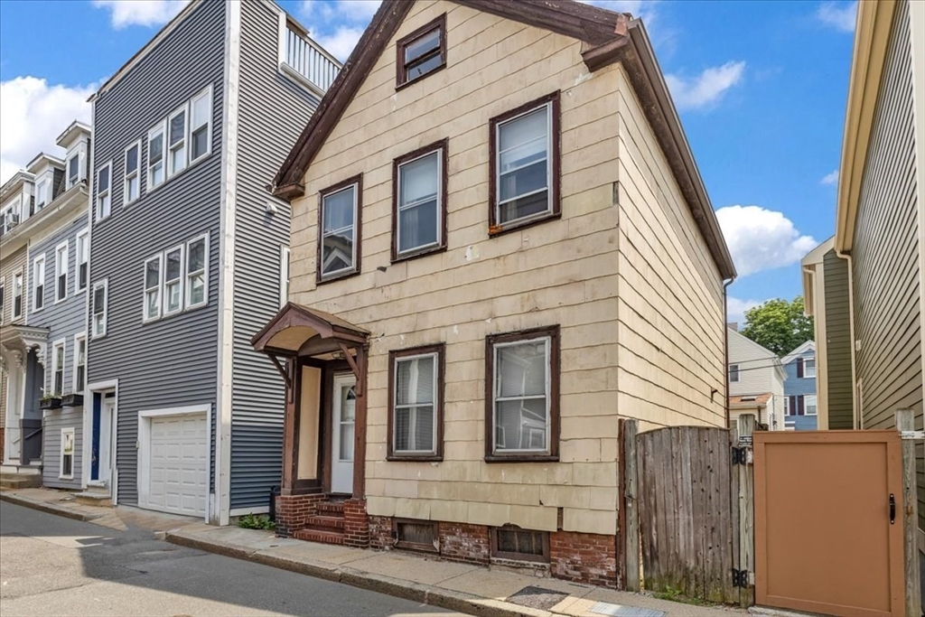 4 Springer Street Boston, MA 02127 - Photo 2 of 18 a front view of a house with a yard