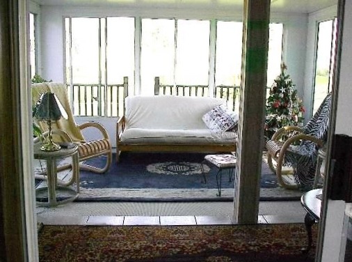 746 Moffet Road Paw Paw, IL 61353 - Photo 4 of 8 a living room with furniture and a floor to ceiling window