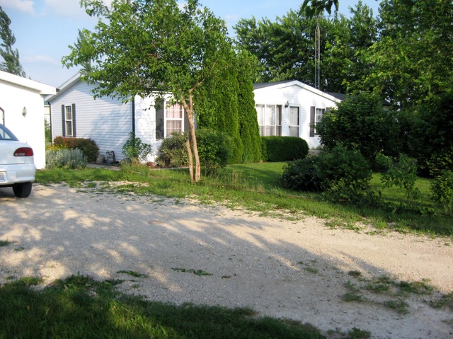746 Moffet Road Paw Paw, IL 61353 - Photo 8 of 8 a front view of a house with a yard and shrubs