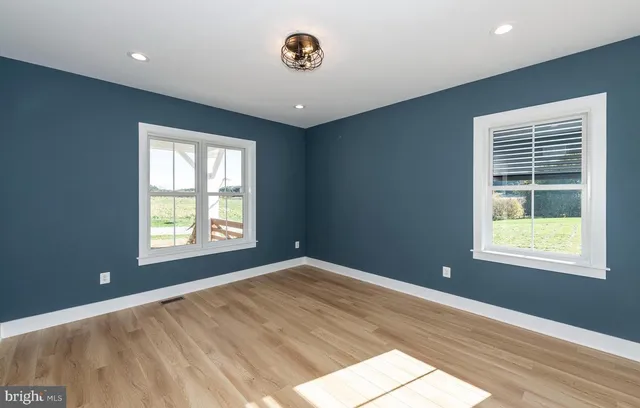 a white bath tub sitting under a bathroom window