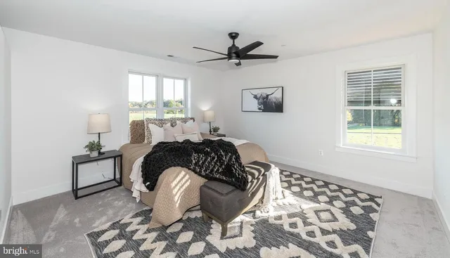 a bathroom with a toilet a sink a mirror a vanity and window