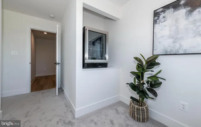 a view of a hallway with wooden floor and stairs