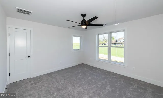 a view of an empty room with gym equipment